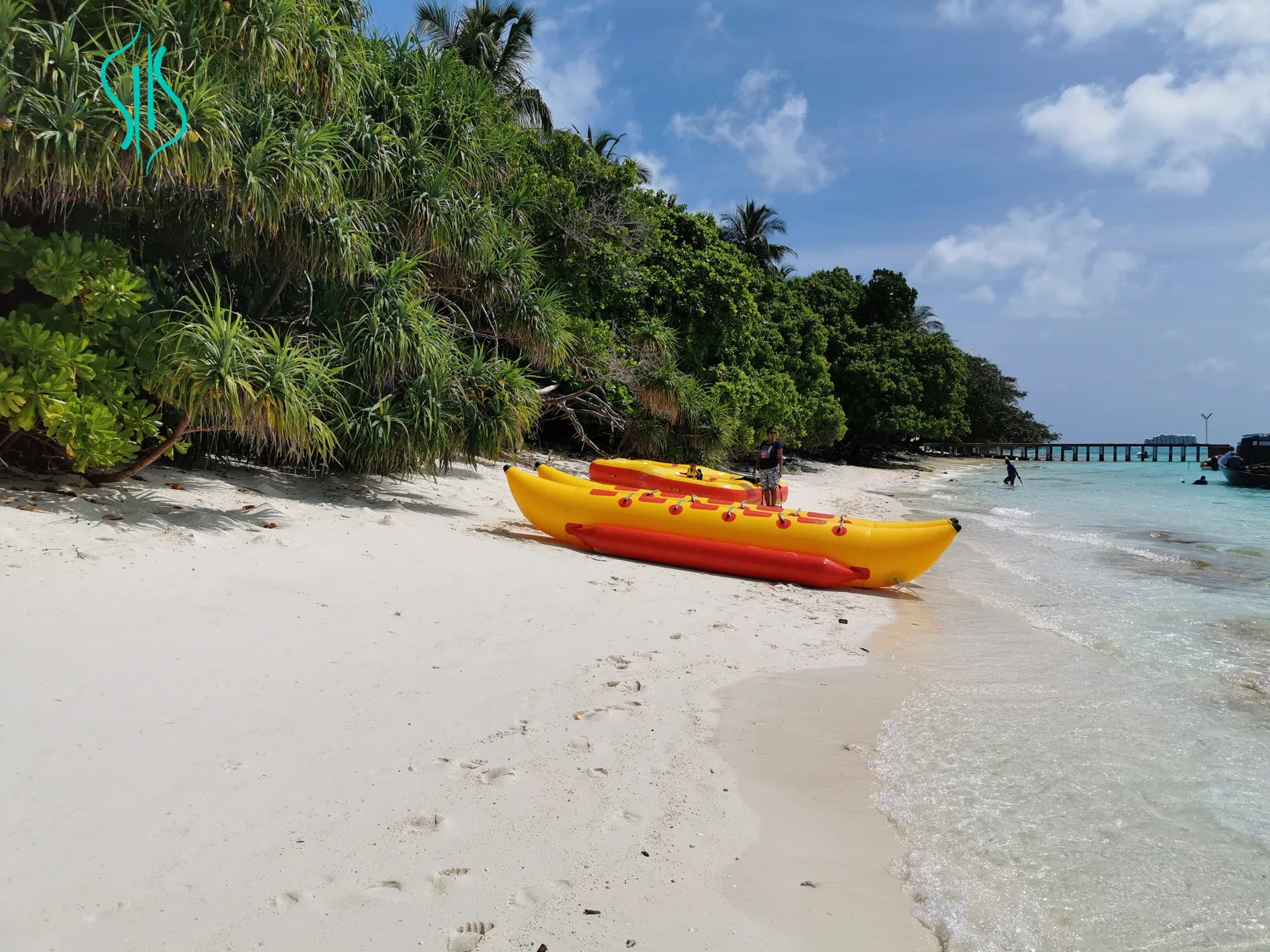 Kayaks resting on the white sands beside the lagoon